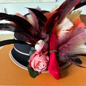 Chic Black Hat with Vibrant Feather and Rose Details
